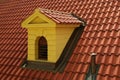 Traditional red tiled roof with a small window. Royalty Free Stock Photo