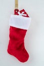 Traditional red and white plush Christmas stocking stuffed with a wrapped present Royalty Free Stock Photo