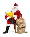 Traditional red white Santa claus reading golden book