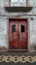 red wooden door on a mosaic road, Horta, Azores Royalty Free Stock Photo