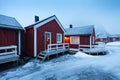 Traditional red wooden houses on the shore of Reine fjord. Beautiful winter scene of Vestvagoy island. Picturesque morning view Royalty Free Stock Photo