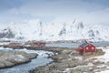 Traditional red wooden houses on the shore of Reine fjord. Beautiful winter scene of Vestvagoy island. Picturesque morning view Royalty Free Stock Photo