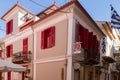 Traditional rennovated classical building and Greek flags in Nafplion. Royalty Free Stock Photo