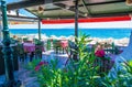 Traditional restaurant outdoor seating overlooking beach Kamari Santorini Greece