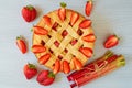 Traditional rhubarb strawberry pie on the gray kitchen table. Veggie berries tart decorated with organic fresh strawberries Royalty Free Stock Photo