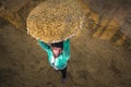 Traditional Rice Mill Worker turn over paddy for drying