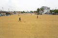 Traditional Rice Mill Worker turn over paddy for drying