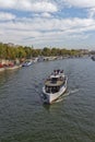 A traditional River Vessel carrying Tourists along a scenic River Cruise through Central Paris