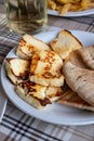 Traditional roasted or grilled halloumi cheese from Cyprus served hot with flat bread