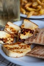 Traditional roasted or grilled halloumi cheese from Cyprus served hot with flat bread