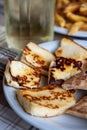 Traditional roasted or grilled halloumi cheese from Cyprus served hot with flat bread