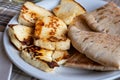 Traditional roasted or grilled halloumi cheese from Cyprus served hot with flat bread