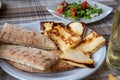 Traditional roasted or grilled halloumi cheese from Cyprus served hot with flat bread