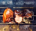 Traditional roasted shank cooking on charcoal spit roaster