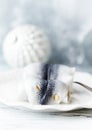 Traditional rollmops, pickled herring on bright wooden background. Royalty Free Stock Photo