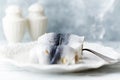 Traditional rollmops, pickled herring on bright wooden background. Royalty Free Stock Photo