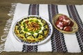 Traditional Romanian boeuf (beef) salad decorated and red Easter eggs with a traditional towel on a wooden table Royalty Free Stock Photo