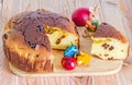 Traditional romanian cake called Pasca with colored easter eggs, bunny, wood background. Royalty Free Stock Photo