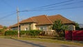 Traditional Romanian farm along a street with electical wiring in the air in the village of Aurel Vlaicu