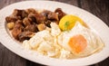 Traditional Romanian food called tochitura made of fried eggs, polenta and pork meat