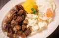 Traditional Romanian food called tochitura made of fried eggs, polenta and pork meat