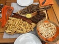 Traditional Romanian food platter with mici, sausages, fries and bread Royalty Free Stock Photo