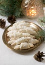 Traditional Romanian or Moldovan shortcake cookies with jam stuffing and a cup of tea on the background of winter decor. Royalty Free Stock Photo