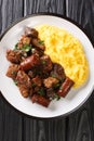 Traditional Romanian Pork Alms Pomana Porcului close-up in a plate. Vertical top view