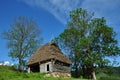 Traditional Romanian wooden barn with thatched roof Royalty Free Stock Photo