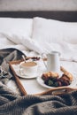 Traditional romantic breakfast in bed in white and beige bedroom Royalty Free Stock Photo