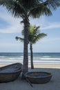 Traditional round Vietnamese boats and palm trees on Danang beach Royalty Free Stock Photo