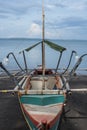 Traditional rowboat on a volcanic beach at Tabaco in the Philippines