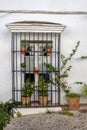 Traditional rural house balcony decorated with flower pots. Royalty Free Stock Photo