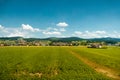 Traditional rural landscape with small houses and green fields in Switzerland. Royalty Free Stock Photo