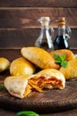 Traditional Russian cabbage pies on wooden background. Baked homemade pirozhki with cabbage