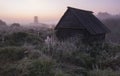 Russian countryside village with wooden windmill in autumn fog with first frosts at dawn Royalty Free Stock Photo