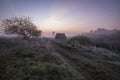 Russian countryside village with wooden windmill in autumn fog with first frosts at dawn Royalty Free Stock Photo