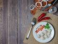 Traditional Russian dumplings, ravioli, pelmeni on a white plate with red sauce and parsley. Dark wooden background Royalty Free Stock Photo