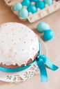 Traditional Russian Easter cake and blue colored eggs in the paper egg box Royalty Free Stock Photo