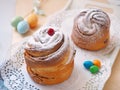 Traditional Russian easter cake. Cruffin dessert, decorated with sugar powder, cranberries and easter eggs. Homemade treat. Royalty Free Stock Photo