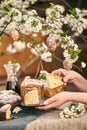 Traditional russian Easter. Woman hands take Orthodox paskha, kulich cakes on table.