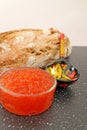 Traditional russian food - red caviar. Wooden spoon painted in traditional style Khokhloma. Royalty Free Stock Photo