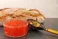 Traditional russian food - red caviar. Wooden spoon painted in traditional style Khokhloma. Royalty Free Stock Photo