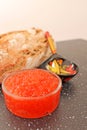 Traditional russian food - red caviar. Wooden spoon painted in traditional style Khokhloma. Royalty Free Stock Photo