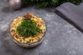 Traditional Russian Olivier salad in glass bowl on gray background. Holiday salad looks like Christmas tree. Copy space Royalty Free Stock Photo