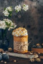 Traditional Russian Orthodox Easter bread kulich with apple blossom and colored eggs in rustic style background Royalty Free Stock Photo