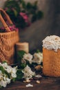 Traditional Russian Orthodox Easter bread kulich with apple blossom and colored eggs in rustic style background with a basket Royalty Free Stock Photo