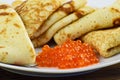 Traditional Russian pancakes with red caviar.