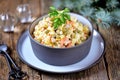 Traditional Russian salad Olivier on an old wooden background. Russian kitchen. Royalty Free Stock Photo