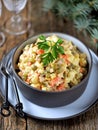 Traditional Russian salad Olivier on an old wooden background. Russian kitchen. Royalty Free Stock Photo